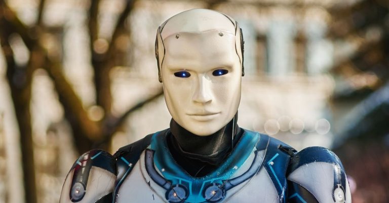 Close-up of a humanoid robot with a futuristic design posing outdoors.