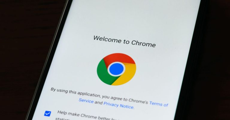 Close-up of smartphone displaying Google Chrome's welcome page and logo.