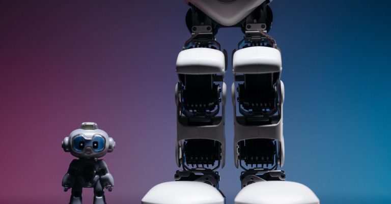 A large robot stands beside a small toy robot with colorful studio lighting, showcasing technology innovation.