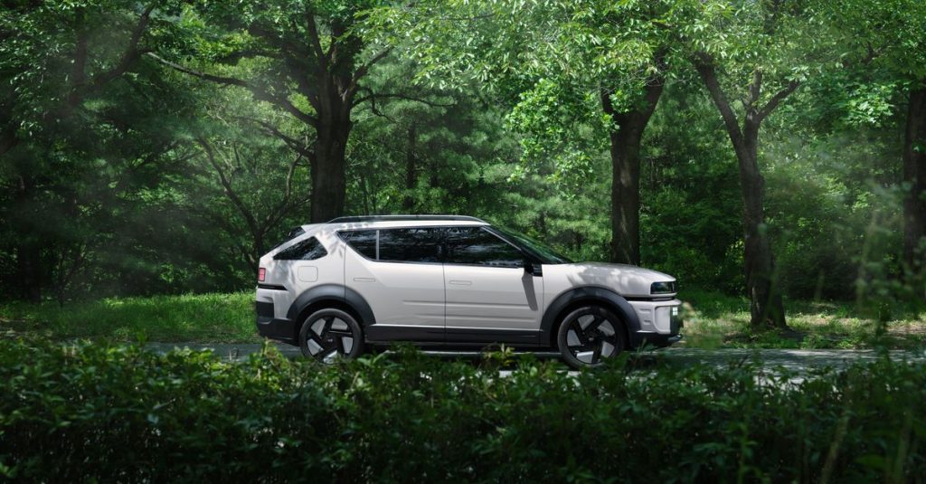 A modern electric SUV parked in a serene forest, blending nature and technology.