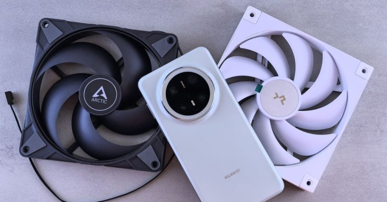 Image of a smartphone alongside two cooling fans on a textured gray surface.