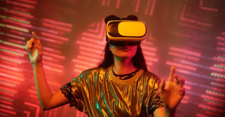 Woman in a metallic top using a virtual reality headset immersed in a digital environment with vibrant lights.