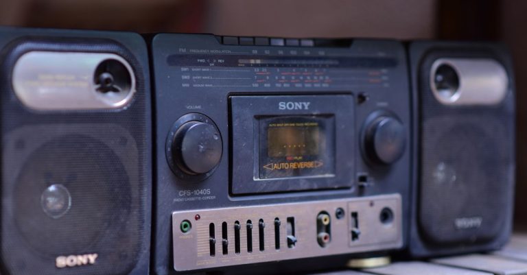 Close-up of a vintage Sony boombox cassette player with speakers on a wooden surface.