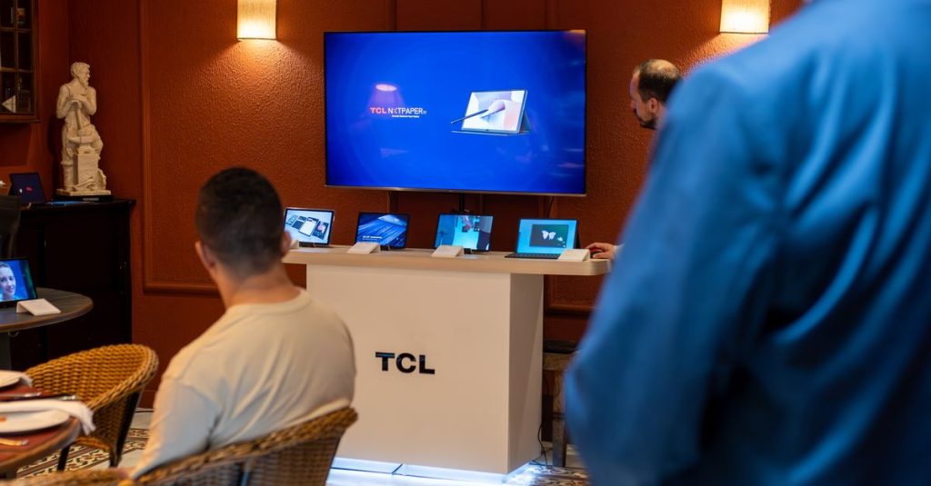 A professional business presentation showcasing new, sleek tablets and technology in a modern showroom setting.