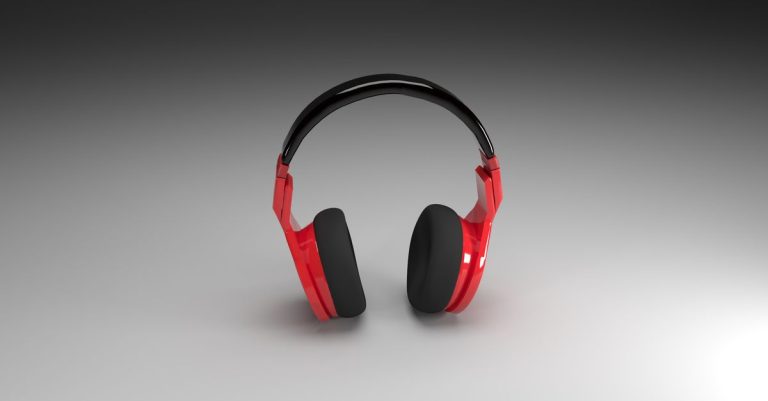Vibrant red headphones isolated on a smooth gray gradient background, perfect for music and technology themes.