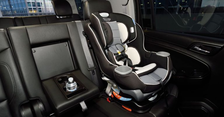Safety car seat securely installed in the back of a modern vehicle. Ideal for family travel.