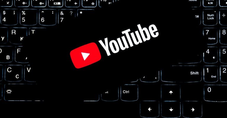 YouTube logo displayed on a backlit keyboard, representing digital media and online content creation.